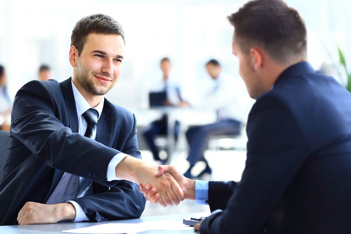 Two business workers shaking hands