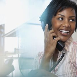 A smiling woman chatting on the phone