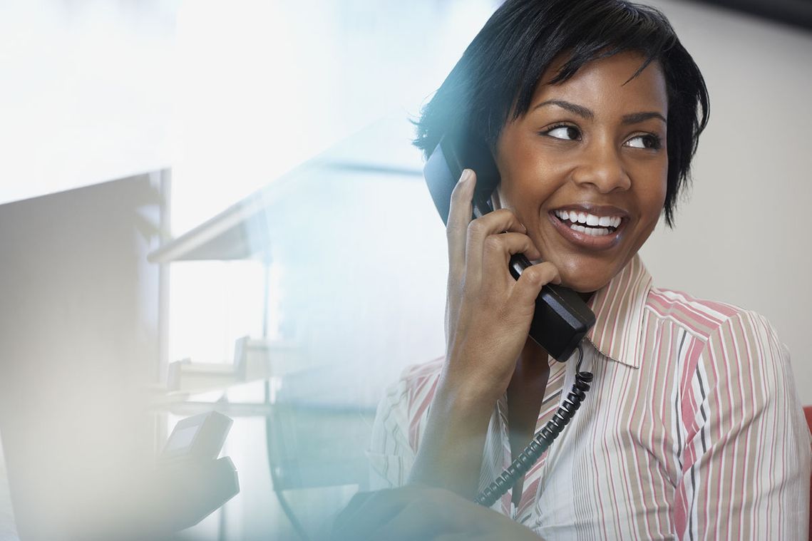 A smiling woman chatting on the phone